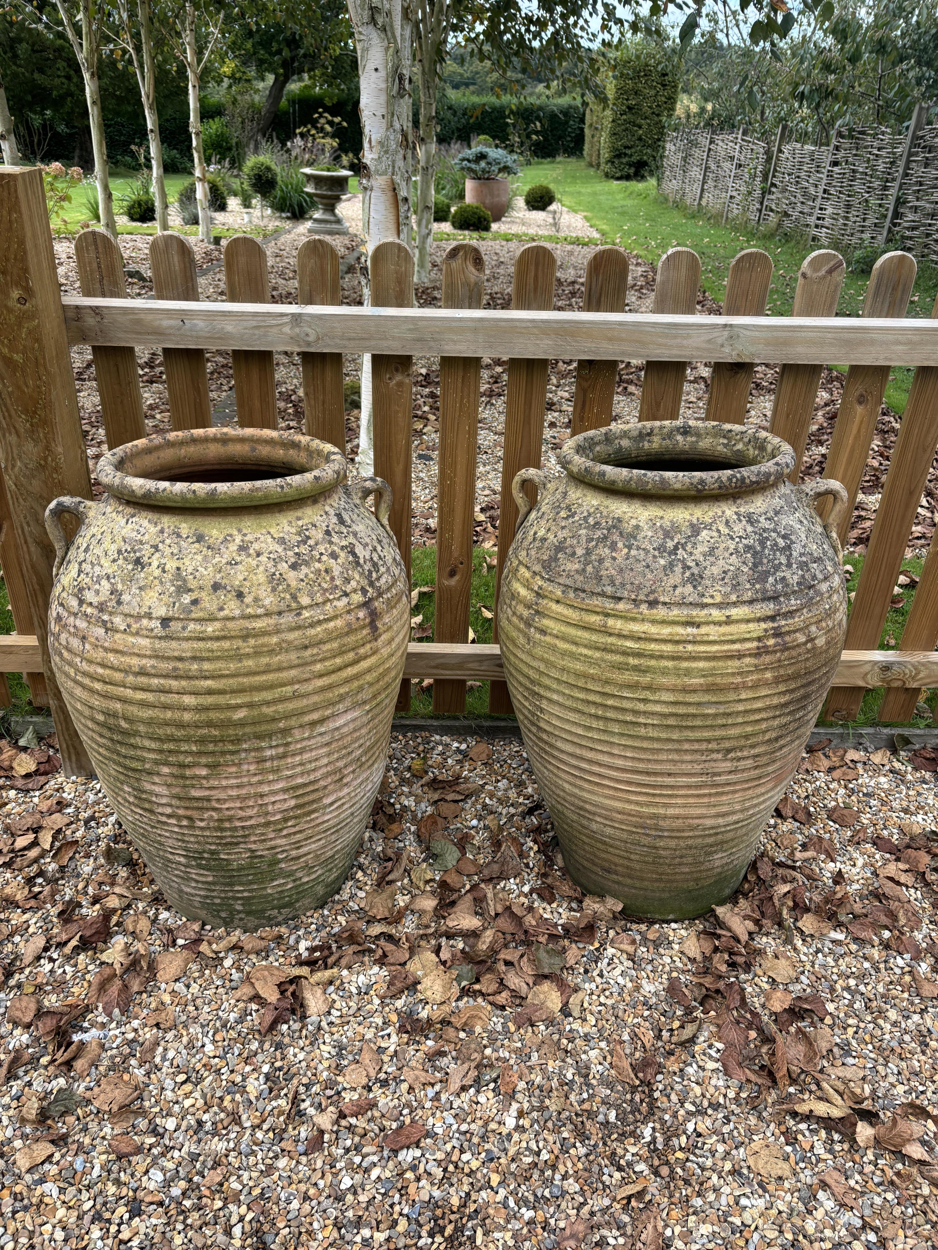 A pair of Italian style terracotta urns, height 75cm, width 48cm. Condition - weathered, otherwise good